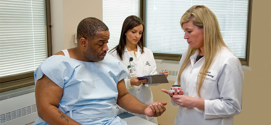 A doctor, medical assistant, and patient