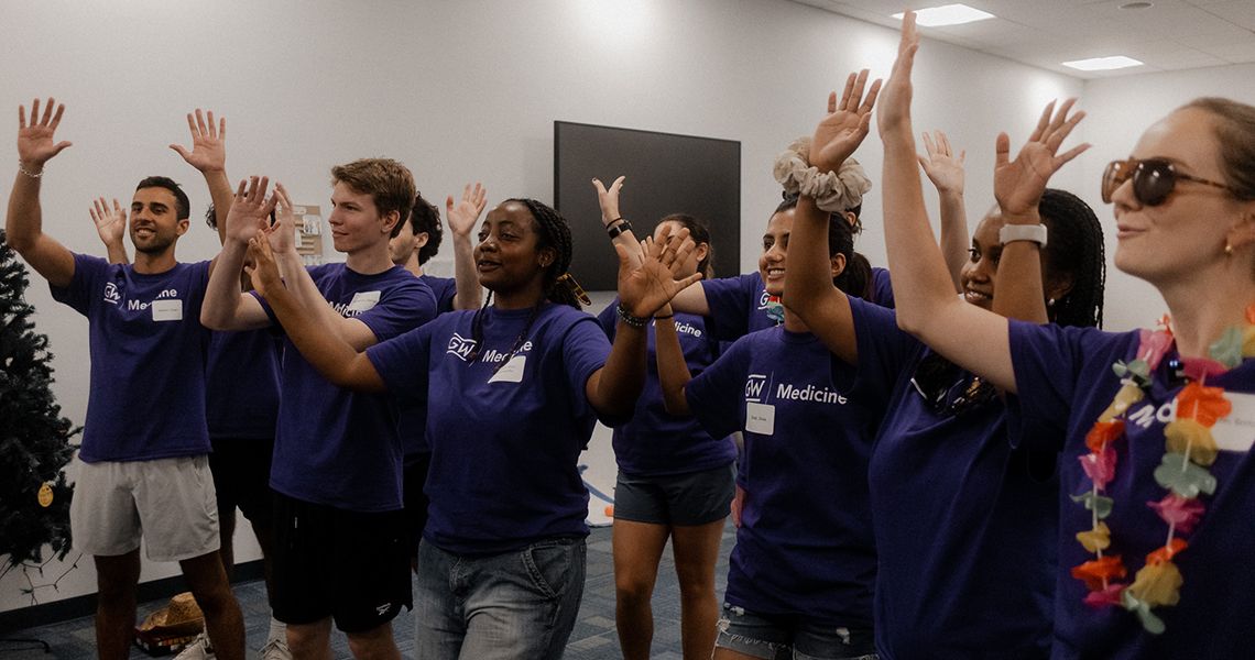 MD Class of 2025 raise hands during orientation