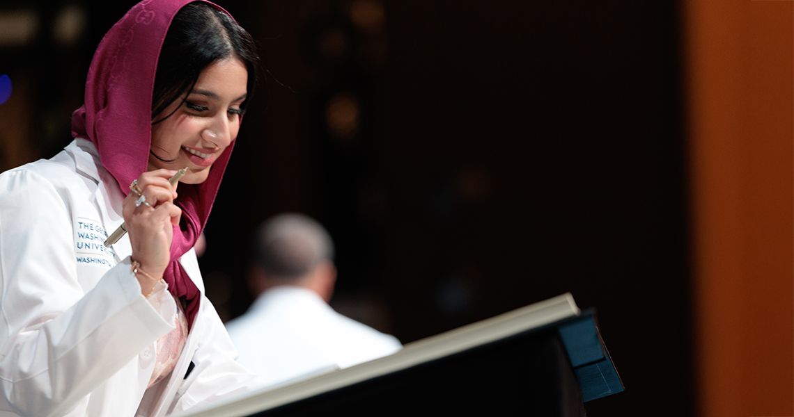 Female student in scarf signs MD program honor code