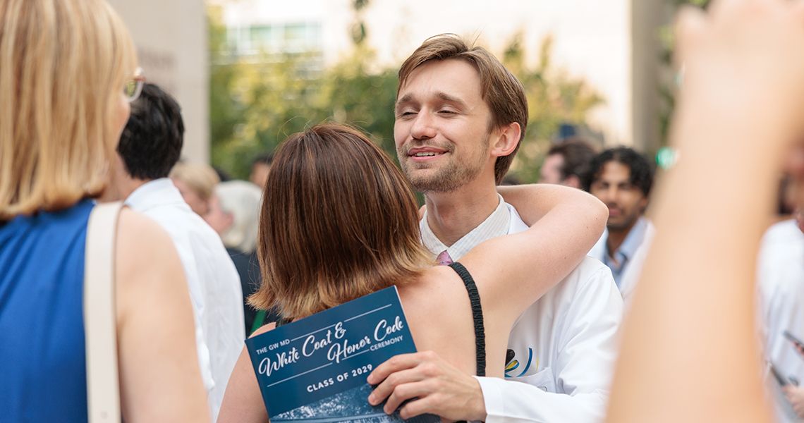 Make student hugs family in outside after event