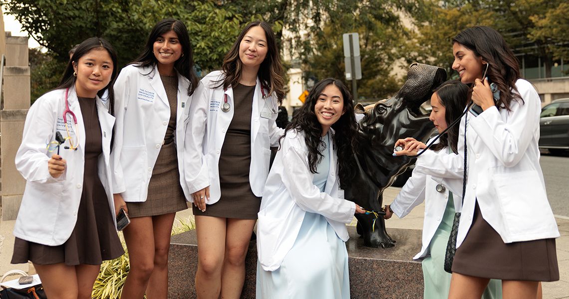 Six femail students pose around Hippo outside Lisner Auditorium