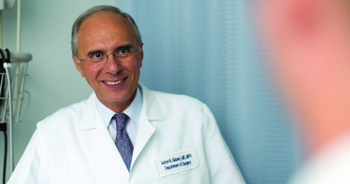 Anton Sidawy in clinic wearing white coat