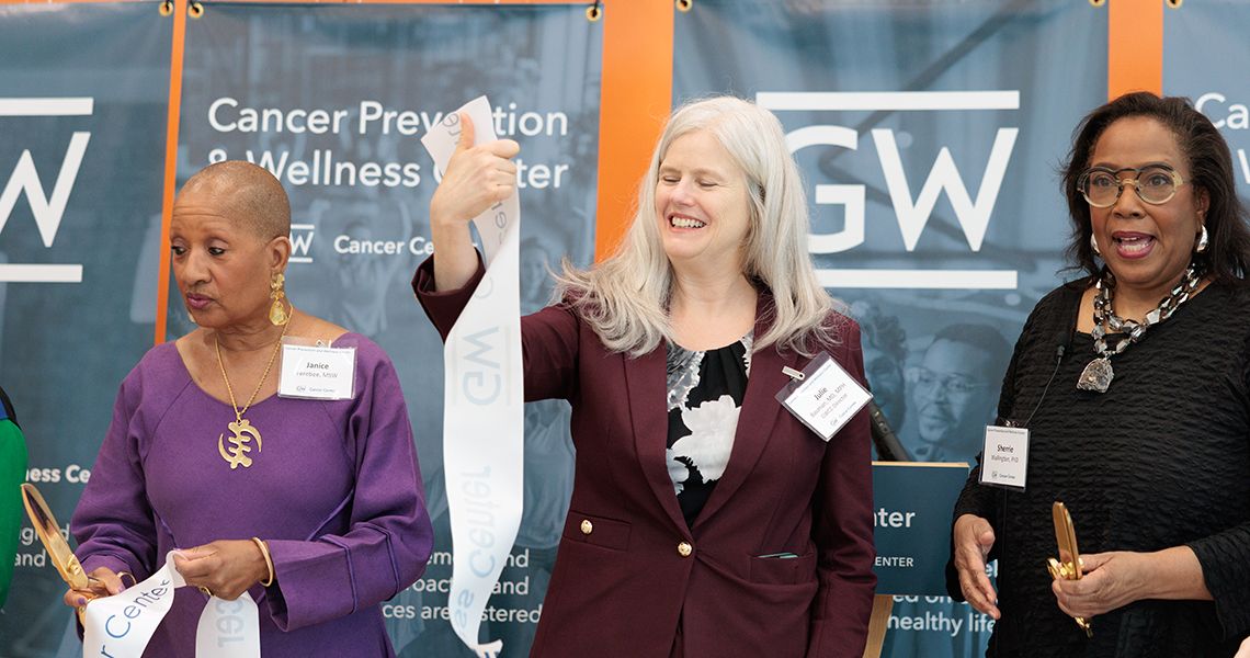 Julie Bauman, MD, MPH, holds up a piece of the ribbon from the event