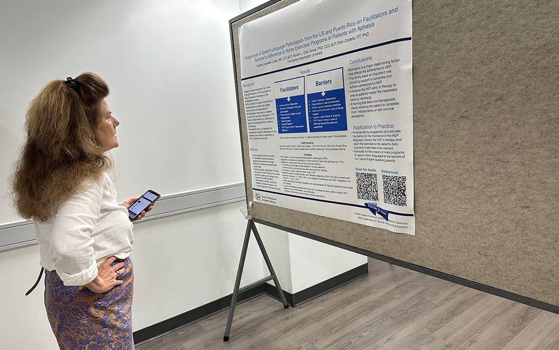 Judge Ellen Costello reviewing a research poster