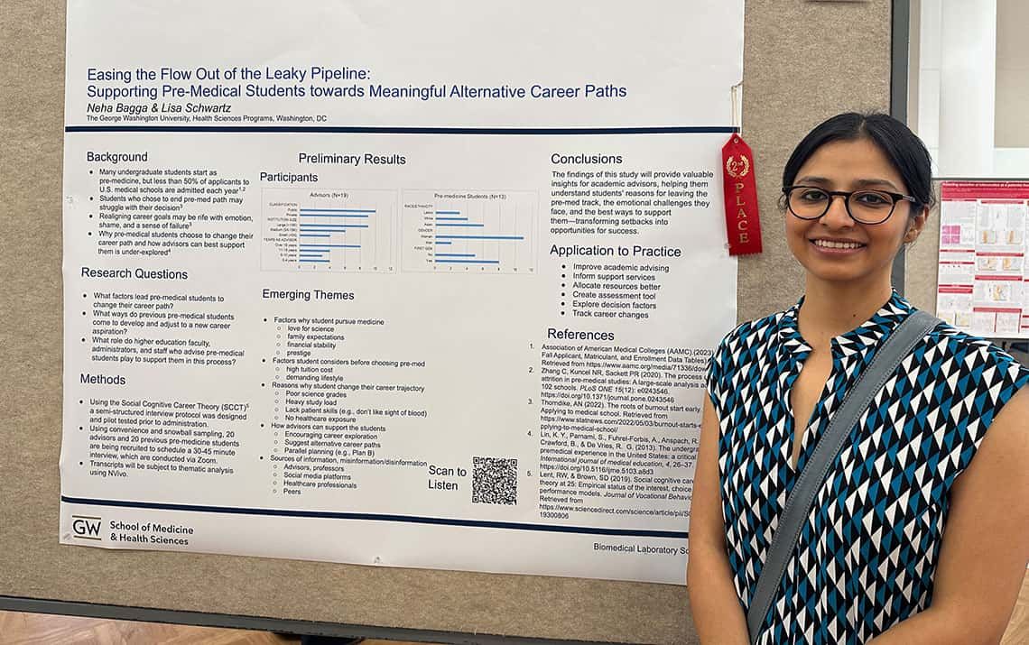 Undergraduate student Neha Bagga standing with her 2nd-place winning research poster