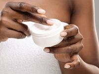 Woman preparing to apply lotion to her skin