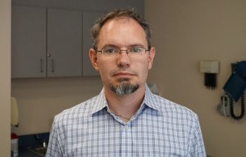 Dr. Brandon Kohrt standing in a lab for a portrait