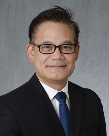 Roger Ideishi smiling for a portrait