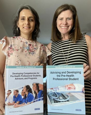 Rohini Ganjoo, PhD, and Lisa Schwartz, EdD, hold the textbooks they edited.
