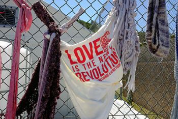 A flag that says 'Love is the new revolution'