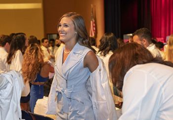 A woman is shown during a White Coat ceremony