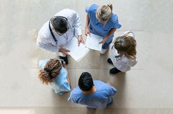 Medical professionals standing together in a circle