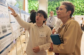 Student presenting research to Dean Haywood