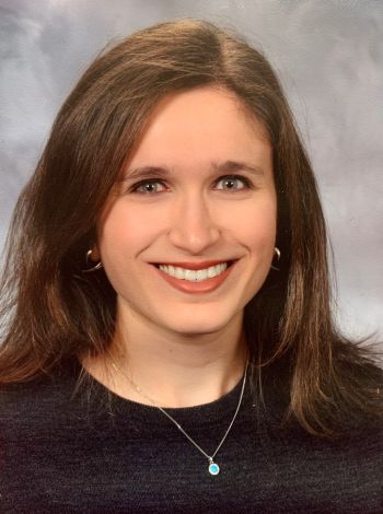 Image of a woman with brown hair wearing a black shirt
