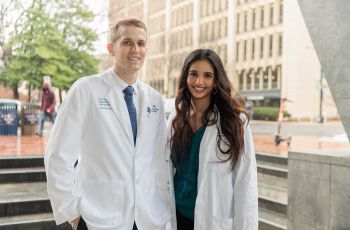 Wyn Dobbs and Shaitalya Sri Vellanki, MD, stand next to each other and smile