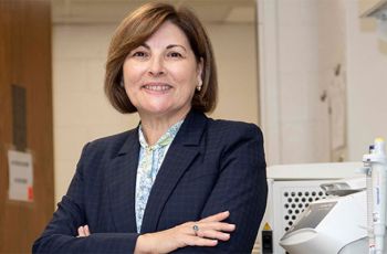 Dr. Antonia Sepulveda posing for a portrait in a lab with her arms crossed