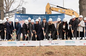 Mayor Muriel Bowser and others stab shovels into the site of the Cedar Hill Regional Medical Center