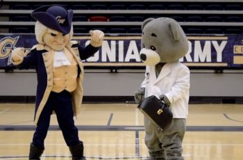 The George Washington and Dr. Bear mascots standing together on the GW basketball court