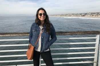 Kiana Khosravian standing in front of the ocean on a bridge