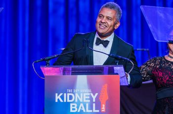 Dr. Keith Melancon speaking from a podium that reads 'The 39th annual kidney ball'