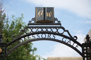 GW Professors Gate in front of a blue sky