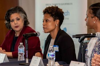 Three panelists sitting in front of microphones at the annual Thought Leadership Summit