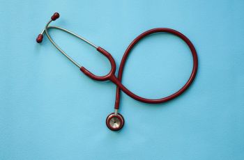 A stethoscope resting on a blue table