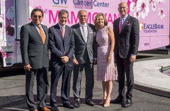 GW medical faculty standing in front of a pink van