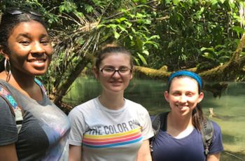 Three DPT students standing together by a river