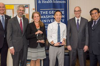 Norman Lee, PhD, and Catherine Bollard, MD, holding awards at the 2017 Faculty Research Awards