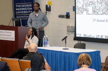 Dr. Ibram X. Kendi standing at a podium in front of a room of people