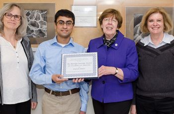 MD student Danish Imtiaz holds an award and stands with GW faculty