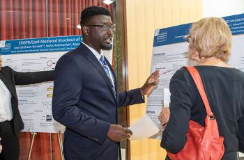Two GW medical students presenting their research posters