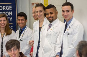 GW Public Health students in white coats standing together
