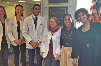Students pose with legislative aides from Senator Dick Durbin's (D-Ill.) office during the #ProtectOurPatients campaign