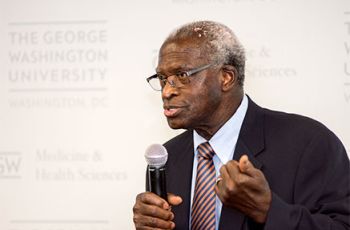 Dr. Cecil Jonas speaking with a microphone 
