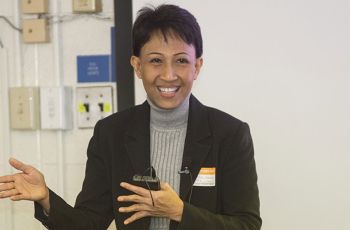 Pimjai Sudsawad smiling and presenting