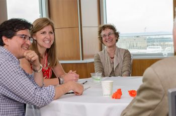 Christina Puchalski, M.D., center, chats with GWish Summer Institute participants at at a table