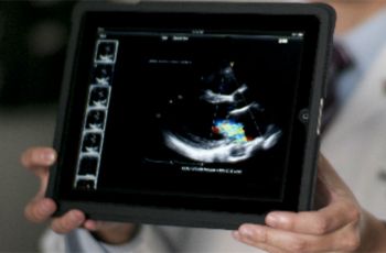 Doctor holds iPad displaying medical test