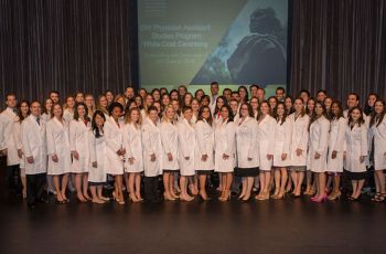 The PA Class of 2016 standing together in white coats
