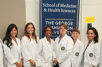 Members of the class of 2016 wearing white coats