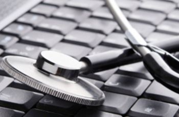 A stethoscope resting on a computer keyboard