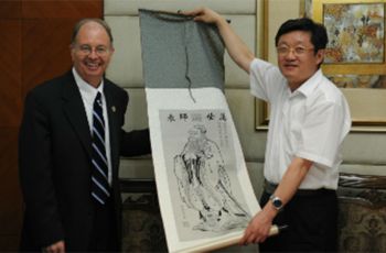 Robert G. Hawley being presented with art by another man