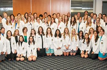 Physician Assistant Studies students pose in white coats