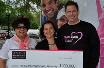 Mandi Pratt-Chapman, holding a $100,000 grant from the Avon Foundation next to two other people