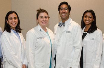 SMHS Residents pose in their long white coats 
