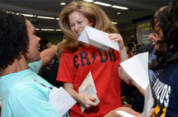 Woman holding her residency match letter jumping for joy