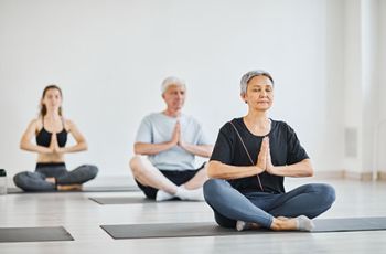 Yoga practitioners sitting in lotus position