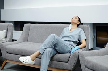 Stressed doctor resting on couch