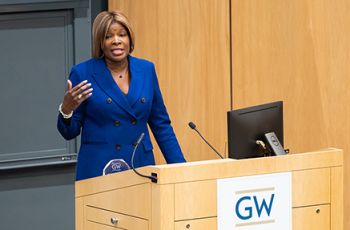 Dr. Nesbitt speaking at a podium at GW.